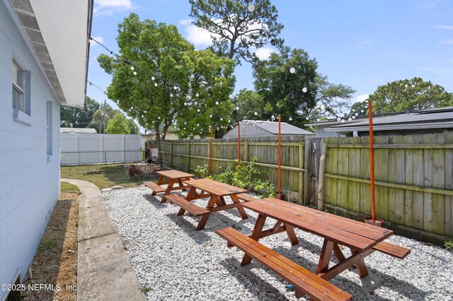 3121 Holly Berry Ln, Jacksonville, FL 32277 - fenced backyard featuring outdoor dining area