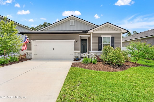 3430 Traceland Oak Ln, Green Cove Springs, FL 32043 - view of front of home with a front lawn, board and batten siding, driveway, and an attached garage