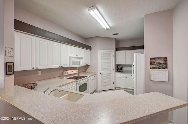 112 Laurel Wood Way Unit 202, Saint Augustine, FL 32086 - kitchen featuring white appliances, a sink, a textured ceiling, white cabinetry, and light countertops