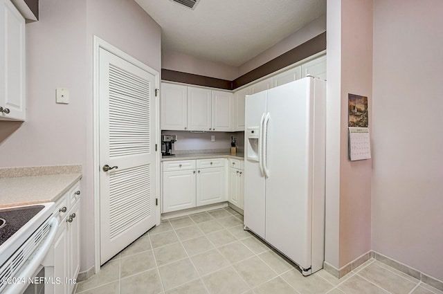 112 Laurel Wood Way Unit 202, Saint Augustine, FL 32086 - kitchen with white appliances, white cabinets, light countertops, and light tile patterned flooring