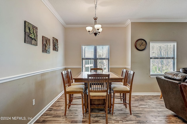 112 Laurel Wood Way Unit 202, Saint Augustine, FL 32086 - dining room with a chandelier, wood finished floors, ornamental molding, and baseboards
