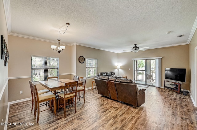 112 Laurel Wood Way Unit 202, Saint Augustine, FL 32086 - dining room with a textured ceiling, wood finished floors, a chandelier, baseboards, and ornamental molding