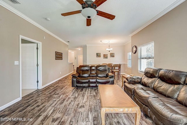 112 Laurel Wood Way Unit 202, Saint Augustine, FL 32086 - living area with wood finished floors, baseboards, crown molding, a chandelier, and a ceiling fan