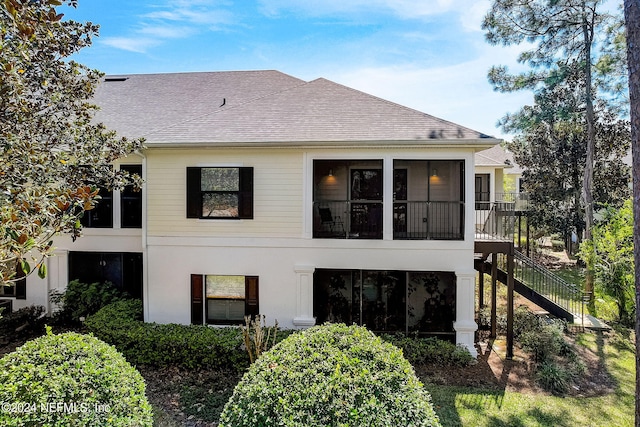 112 Laurel Wood Way Unit 202, Saint Augustine, FL 32086 - back of house with a sunroom, a shingled roof, stairway, and stucco siding