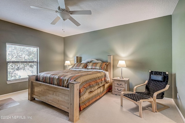 112 Laurel Wood Way Unit 202, Saint Augustine, FL 32086 - bedroom featuring light colored carpet, baseboards, a textured ceiling, and ceiling fan