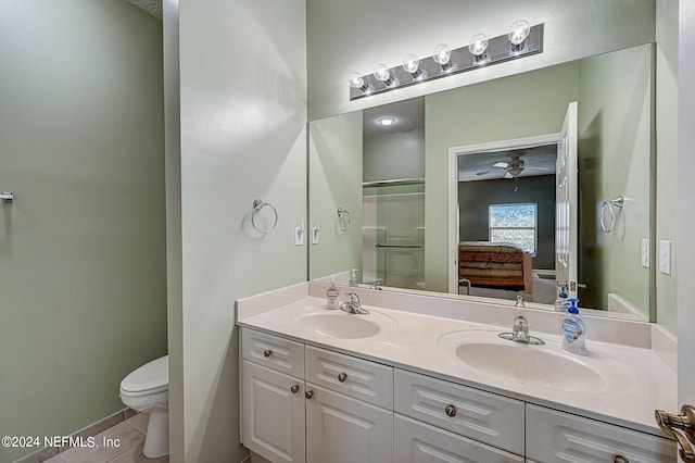 112 Laurel Wood Way Unit 202, Saint Augustine, FL 32086 - bathroom featuring double vanity, connected bathroom, toilet, an enclosed shower, and tile patterned floors