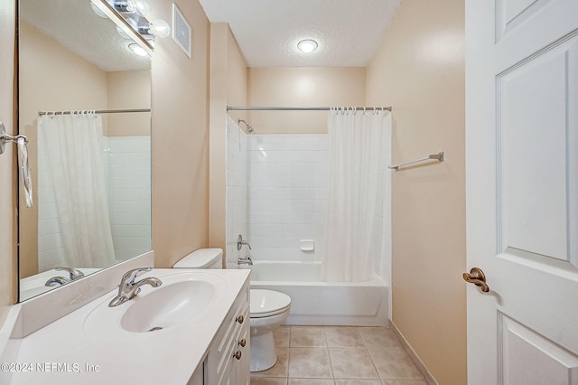 112 Laurel Wood Way Unit 202, Saint Augustine, FL 32086 - bathroom with toilet, a textured ceiling, vanity, shower / tub combo, and tile patterned flooring
