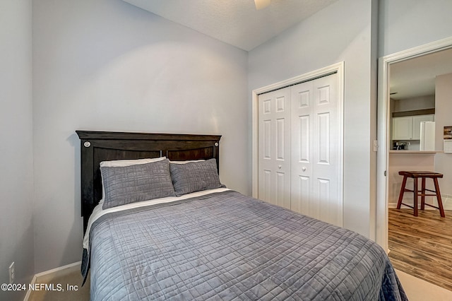112 Laurel Wood Way Unit 202, Saint Augustine, FL 32086 - bedroom featuring baseboards, a closet, and wood finished floors