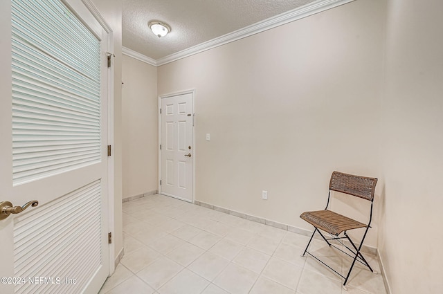 112 Laurel Wood Way Unit 202, Saint Augustine, FL 32086 - unfurnished room with a textured ceiling, crown molding, light tile patterned floors, and baseboards