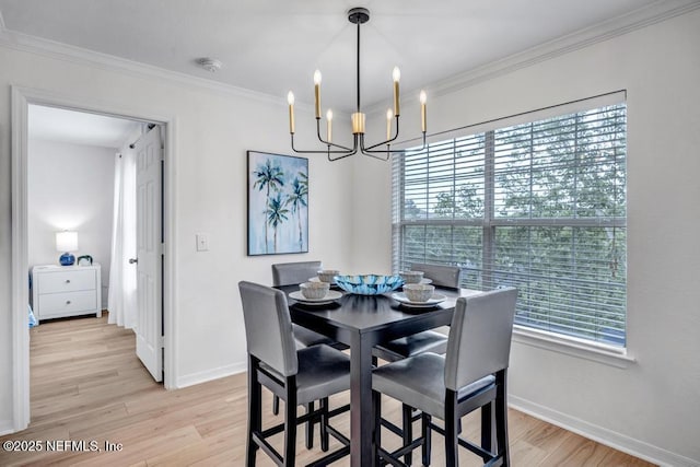 10961 Burnt Mill Rd Unit 1534, Jacksonville, FL 32256 - dining area with a chandelier, light wood-style flooring, baseboards, and ornamental molding