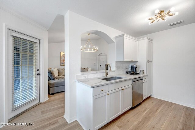 10961 Burnt Mill Rd Unit 1534, Jacksonville, FL 32256 - kitchen with stainless steel dishwasher, a sink, a chandelier, light wood-style floors, and white cabinets