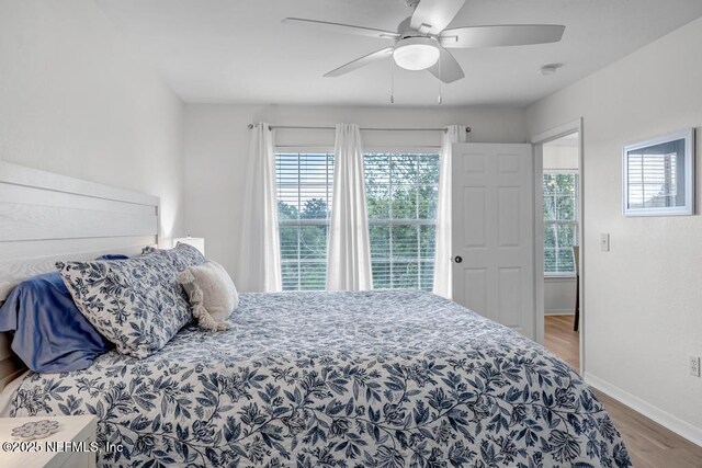 10961 Burnt Mill Rd Unit 1534, Jacksonville, FL 32256 - bedroom featuring wood finished floors, baseboards, and a ceiling fan