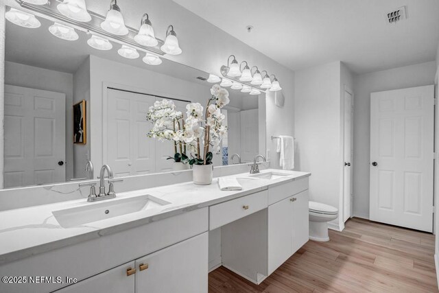10961 Burnt Mill Rd Unit 1534, Jacksonville, FL 32256 - full bathroom with double vanity, wood finished floors, and toilet