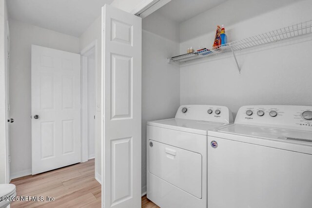 10961 Burnt Mill Rd Unit 1534, Jacksonville, FL 32256 - laundry area with washing machine and dryer, light wood finished floors, and baseboards