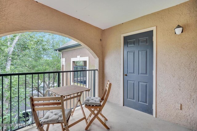 10961 Burnt Mill Rd Unit 1534, Jacksonville, FL 32256 - view of exterior entry featuring a balcony and stucco siding