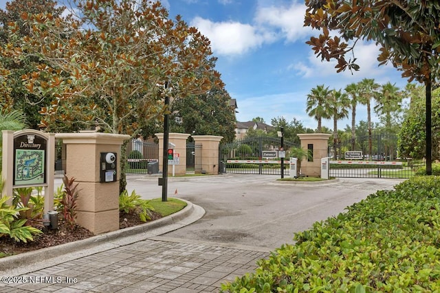 10961 Burnt Mill Rd Unit 1534, Jacksonville, FL 32256 - view of asphalt street featuring a gate, a gated entry, and curbs