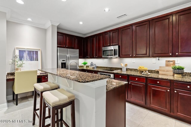 4300 S Beach Pkwy Unit 3313, Jacksonville Beach, FL 32250 - kitchen featuring dark brown cabinets, stainless steel appliances, dark stone counters, ornamental molding, and recessed lighting