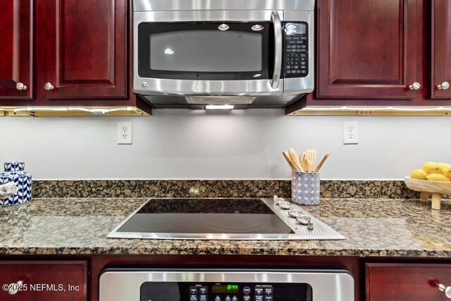 4300 S Beach Pkwy Unit 3313, Jacksonville Beach, FL 32250 - kitchen with stainless steel microwave, dark brown cabinets, black electric cooktop, wall oven, and dark stone countertops