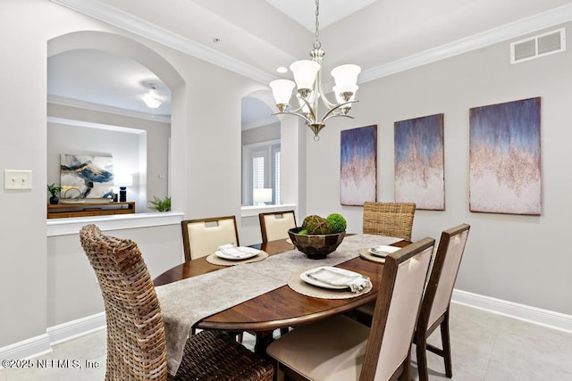 4300 S Beach Pkwy Unit 3313, Jacksonville Beach, FL 32250 - dining space with arched walkways, crown molding, a chandelier, baseboards, and light tile patterned flooring