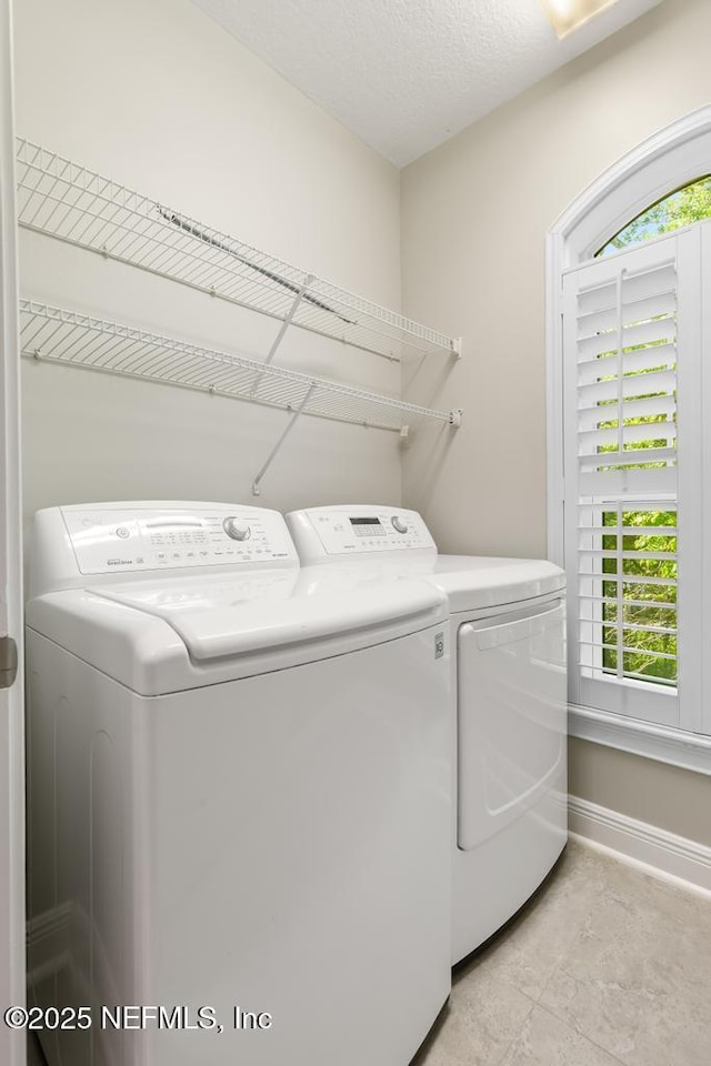 4300 S Beach Pkwy Unit 3313, Jacksonville Beach, FL 32250 - laundry room with washer and dryer, baseboards, and plenty of natural light