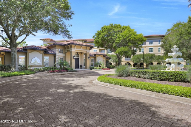 4300 S Beach Pkwy Unit 3313, Jacksonville Beach, FL 32250 - view of front of house with stucco siding, curved driveway, and a tile roof