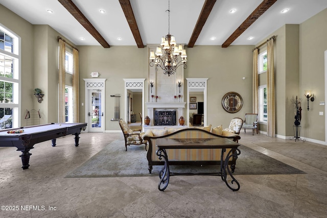 4300 S Beach Pkwy Unit 3313, Jacksonville Beach, FL 32250 - living area with a high ceiling, healthy amount of natural light, a chandelier, billiards, and baseboards