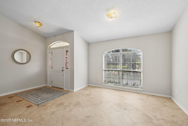 4458 Deep River Way E, Jacksonville, FL 32224 - tiled entryway featuring baseboards and a textured ceiling