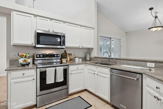 4458 Deep River Way E, Jacksonville, FL 32224 - kitchen featuring appliances with stainless steel finishes, lofted ceiling, white cabinetry, pendant lighting, and light tile patterned floors