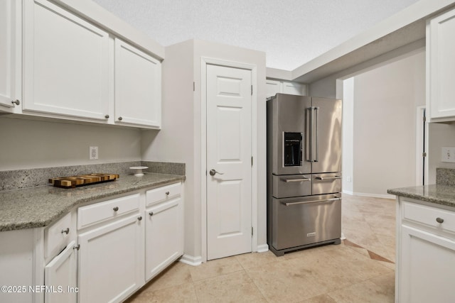 4458 Deep River Way E, Jacksonville, FL 32224 - kitchen with high quality fridge, white cabinets, and light tile patterned floors