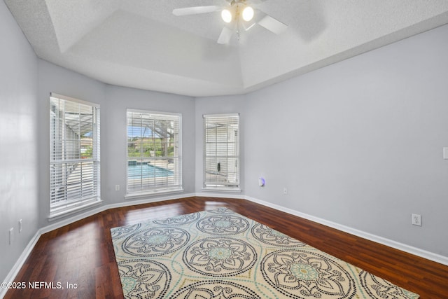 4458 Deep River Way E, Jacksonville, FL 32224 - empty room with wood finished floors, ceiling fan, and a raised ceiling