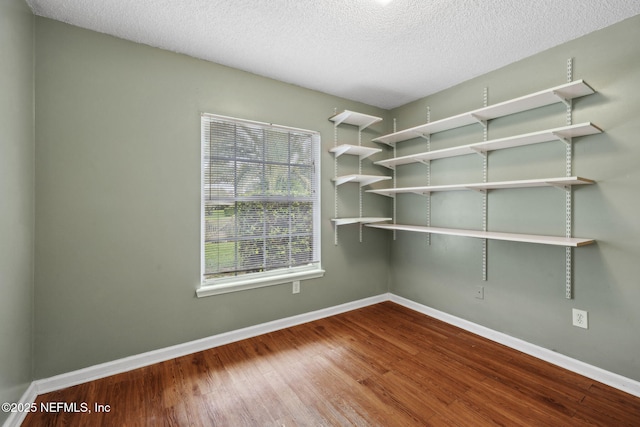 4458 Deep River Way E, Jacksonville, FL 32224 - empty room featuring wood finished floors and a textured ceiling