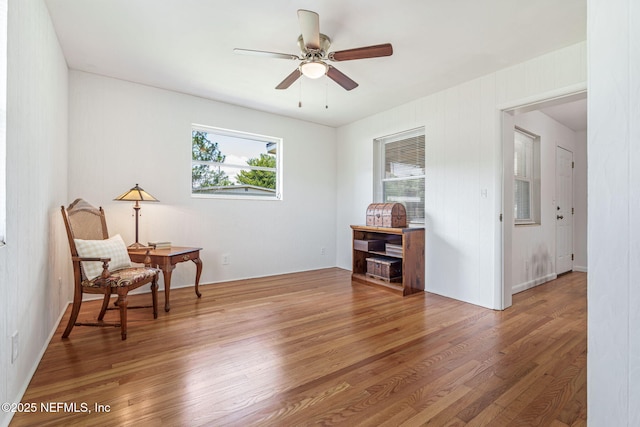3130 Honeywood Dr, Jacksonville, FL 32277 - living area with a ceiling fan, light wood-style flooring, and a desk