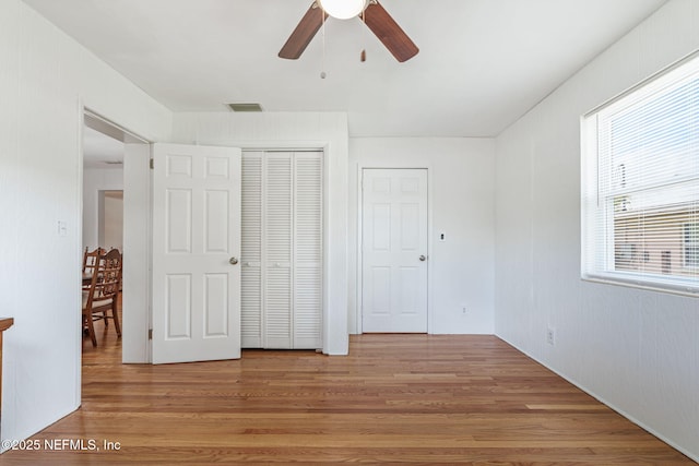 3130 Honeywood Dr, Jacksonville, FL 32277 - unfurnished bedroom with light wood-style floors, a closet, and ceiling fan