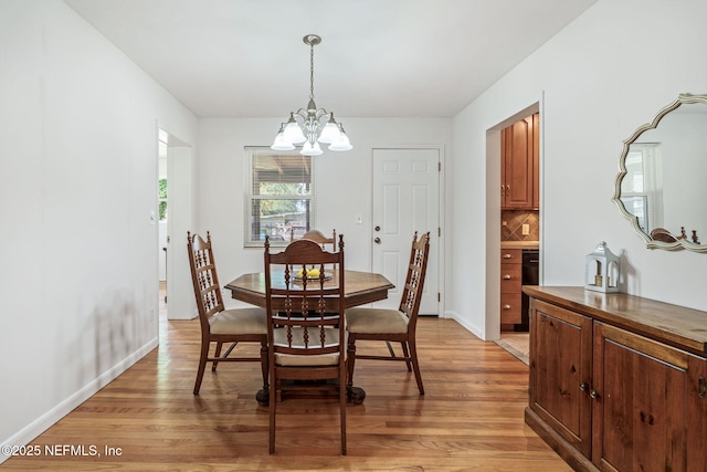 3130 Honeywood Dr, Jacksonville, FL 32277 - dining area with a chandelier, light wood-style flooring, and baseboards