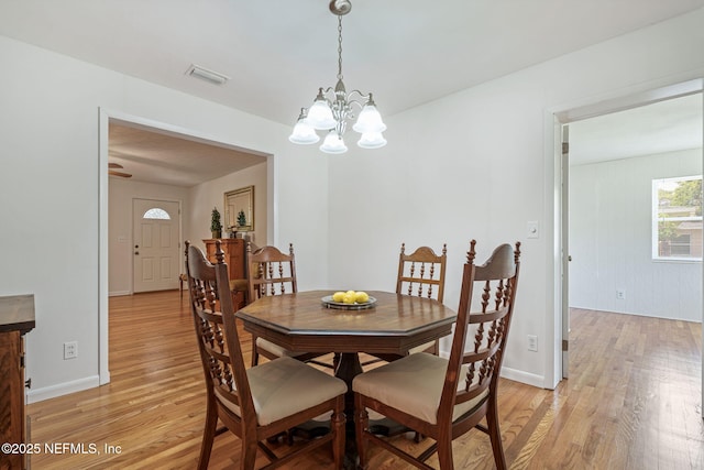 3130 Honeywood Dr, Jacksonville, FL 32277 - dining area with a chandelier, light wood-type flooring, and baseboards