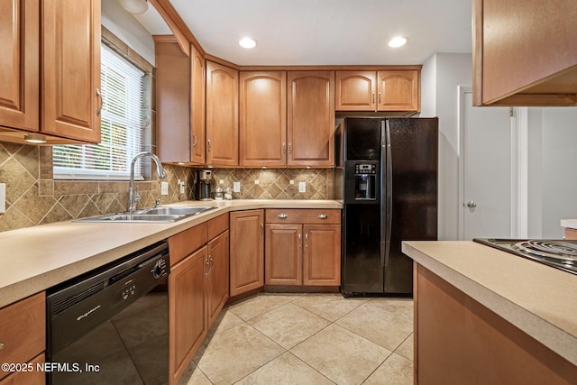 3130 Honeywood Dr, Jacksonville, FL 32277 - kitchen with black appliances, a sink, light countertops, light tile patterned floors, and backsplash