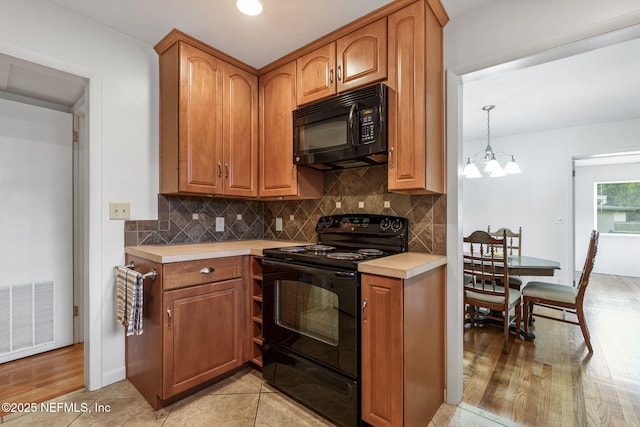 3130 Honeywood Dr, Jacksonville, FL 32277 - kitchen featuring black appliances, light countertops, decorative backsplash, and brown cabinets