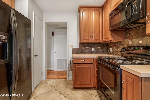 3130 Honeywood Dr, Jacksonville, FL 32277 - kitchen featuring black appliances, light countertops, tasteful backsplash, and light tile patterned flooring