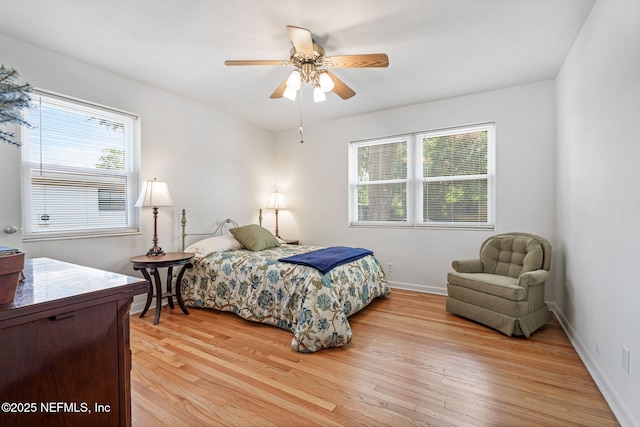 3130 Honeywood Dr, Jacksonville, FL 32277 - bedroom featuring multiple windows, light wood-style floors, baseboards, and ceiling fan