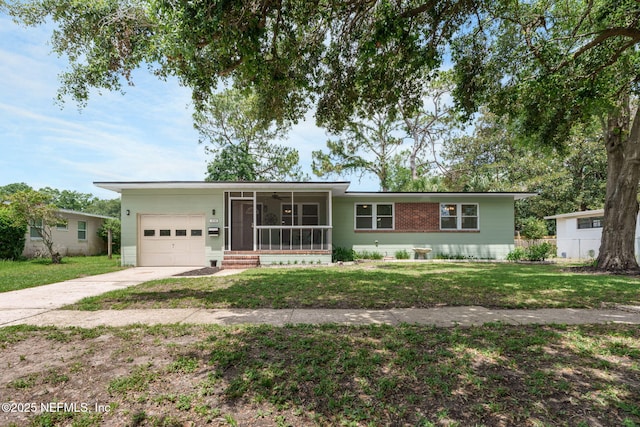 3130 Honeywood Dr, Jacksonville, FL 32277 - single story home with a garage, a sunroom, concrete driveway, and a front lawn