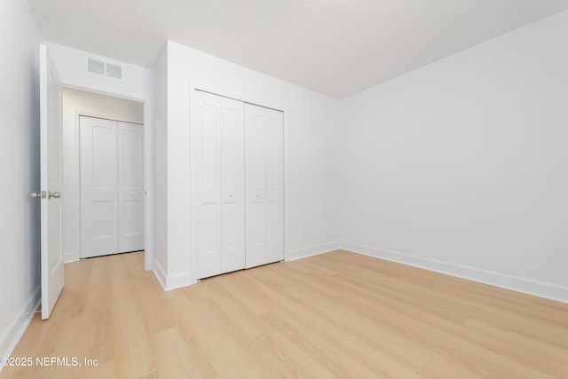 7127 Stetson St, Keystone Heights, FL 32656 - unfurnished bedroom with light wood-type flooring, baseboards, and a closet