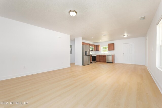 7127 Stetson St, Keystone Heights, FL 32656 - unfurnished living room featuring light wood-style floors, baseboards, a sink, and electric panel