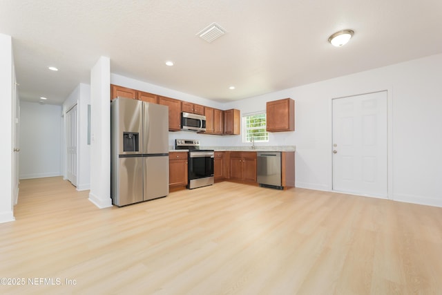 7127 Stetson St, Keystone Heights, FL 32656 - kitchen with stainless steel appliances, light wood finished floors, light countertops, a sink, and recessed lighting