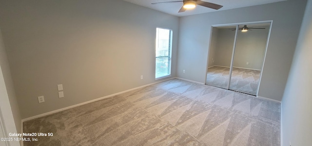 7640 Las Palmas Way Unit 149, Jacksonville, FL 32256 - unfurnished bedroom featuring carpet, a closet, baseboards, and a ceiling fan