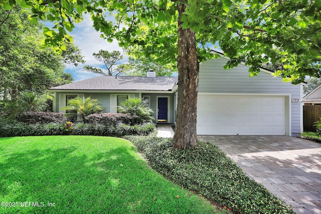 721 Sandy Oaks Ct, Ponte Vedra Beach, FL 32082 - view of front of home featuring decorative driveway, a front lawn, a garage, and a chimney