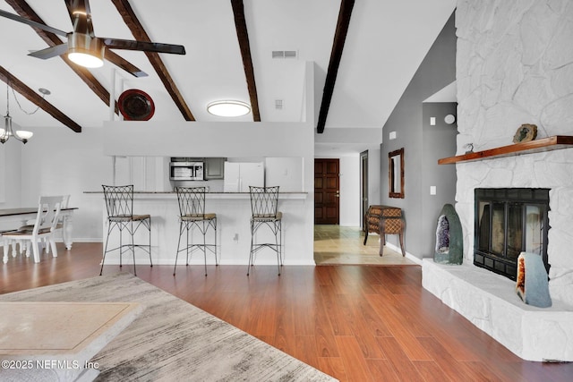 721 Sandy Oaks Ct, Ponte Vedra Beach, FL 32082 - living room with high vaulted ceiling, beam ceiling, wood finished floors, a fireplace, and a ceiling fan