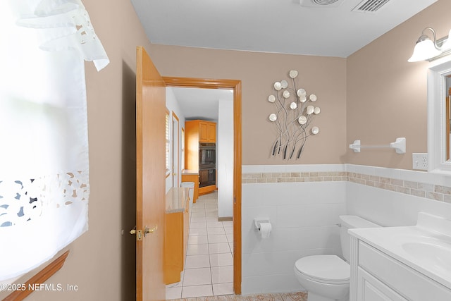 3344 Queen Ann Ln, Jacksonville, FL 32257 - half bath featuring tile patterned floors, vanity, tile walls, and wainscoting