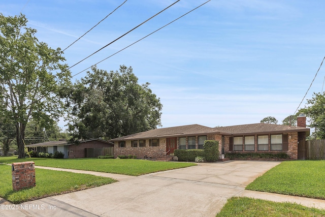 3344 Queen Ann Ln, Jacksonville, FL 32257 - view of front of house featuring driveway, brick siding, and a chimney