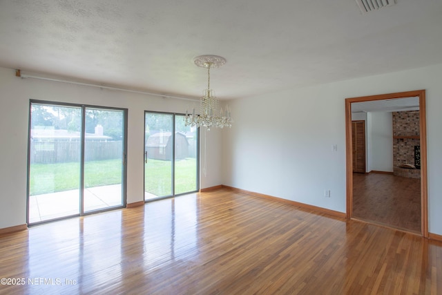 3344 Queen Ann Ln, Jacksonville, FL 32257 - empty room with a chandelier and wood finished floors