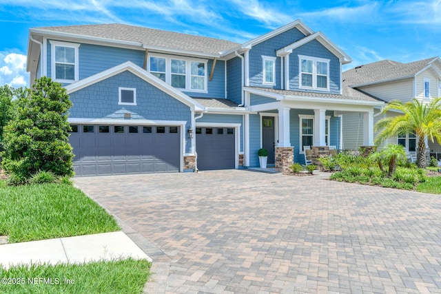 843 Windley Dr, Saint Augustine, FL 32092 - craftsman house with a porch, decorative driveway, stone siding, and an attached garage